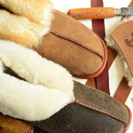 A closeup view from the top of one beige and one brown Ithaca Sheepskin slipper.